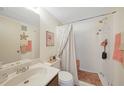 Bathroom featuring a shower with nautical accents, a sink with counter space, and soft lighting at 25225 Rampart Blvd # 1604, Punta Gorda, FL 33983
