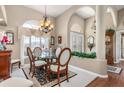 Elegant dining room features a glass table, chandelier, and large window for natural light at 26373 Madagascar, Punta Gorda, FL 33983