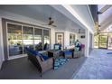 Relaxing covered patio with comfortable seating, ceiling fans, and a view of the pool at 282 Shaefer St, Port Charlotte, FL 33953