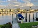 Water view showing a boat on a boat lift at a private residential dock at 3216 Purple Martin Dr # 121, Punta Gorda, FL 33950
