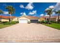 Beautiful home with a well-manicured lawn, tile roof, and large brick driveway, creating great curb appeal at 3748 Albacete Cir # 38, Punta Gorda, FL 33950