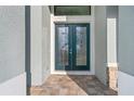 Elegant entryway boasting double doors with decorative glass, complemented by a paver walkway at 4320 Vasco St, Punta Gorda, FL 33950