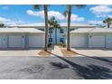 Charming light-blue two-story home with white trim, dual garages, and mature palm trees at 5783 Sabal Trace Dr # 103B57, North Port, FL 34287