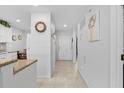 Inviting hallway featuring tile floors, white walls, and seamless transition to other spaces at 5783 Sabal Trace Dr # 103B57, North Port, FL 34287