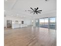 Spacious living room features modern ceiling fan, tile floors, and access to screened lanai at 8604 Shore Lake Dr, Englewood, FL 34224