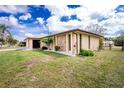 Beautiful home with a stone feature and landscaped yard, offering great curb appeal at 917 Tropical Nw Ave, Port Charlotte, FL 33948