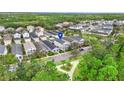 An aerial view of a serene neighborhood with neat rows of houses nestled amidst trees and green spaces at 12492 Shimmering Oak Cir, Venice, FL 34293
