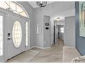 Bright entryway featuring a decorative glass front door and hardwood flooring at 1303 Casey Key Dr, Punta Gorda, FL 33950