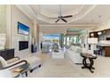 Spacious living room with a fireplace, tv, and open floorplan overlooking the water at 1492 Aqui Esta Dr, Punta Gorda, FL 33950