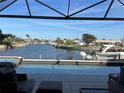 Relaxing water view from the poolside of the home in the outdoor living space at 1492 Aqui Esta Dr, Punta Gorda, FL 33950