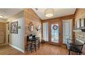 Welcoming entryway with wood-paneled walls, decorative mirror, and light-filled, leaded-glass front door at 1525 Hinton St, Port Charlotte, FL 33952