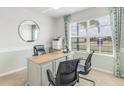 Well-lit home office with a large window, contemporary desk, and comfortable seating, perfect for productivity at 16395 Larocha Dr, Punta Gorda, FL 33955