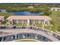 Aerial view of a condo community near a lake with ample parking spaces at 175 Kings Hwy # 538, Punta Gorda, FL 33983