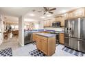 Bright kitchen with stainless steel appliances, wood cabinets, and a center island at 175 Kings Hwy # 538, Punta Gorda, FL 33983