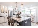 Beautiful kitchen featuring a large center island with seating, stainless appliances, and modern lighting at 18379 Meyer Ave, Port Charlotte, FL 33948