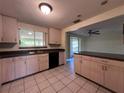 Bright kitchen with a double sink, black appliances, and views to the outdoor patio at 20262 Hamilton Ave, Port Charlotte, FL 33952