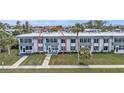 Exterior view of a well-maintained condominium with landscaping and convenient parking at 21287 Gertrude Ave # 106, Port Charlotte, FL 33952