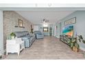 Bright living room featuring tile flooring, a stylish accent wall, and comfortable seating at 21287 Gertrude Ave # 106, Port Charlotte, FL 33952