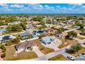 Birds eye view of a light-colored single-story home with a large driveway in a quiet neighborhood at 21332 Walling Ct, Port Charlotte, FL 33954