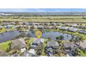 Aerial view of the home showing the lake view, surrounding neighborhood and lush green landscape at 24528 Sunrise Dr, Punta Gorda, FL 33980