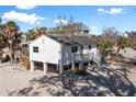 Beautiful raised beach home with a screened-in porch and steps leading to the beach at 2476 N Beach Rd, Englewood, FL 34223