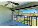Screened lanai featuring tile flooring, ceiling fan, and a view of the water at 3233 Wood Thrush Dr # 23C, Punta Gorda, FL 33950