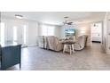 Inviting living room with plush seating, neutral decor, ceiling fan, and abundant natural light at 3348 Pinetree St, Port Charlotte, FL 33952