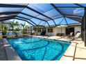 Relaxing screened-in pool area with outdoor seating, perfect for enjoying sunny days and entertaining guests at 3348 Pinetree St, Port Charlotte, FL 33952