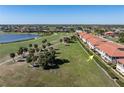 Condo complex aerial showcasing manicured lawns, golf course views, and proximity to a tranquil lake at 3959 San Rocco Dr # 612, Punta Gorda, FL 33950