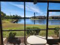 Screened-in patio showcasing a serene lake view, offering a tranquil outdoor living space at 4000 Oakview Dr # L2, Punta Gorda, FL 33980
