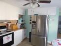 Bright kitchen featuring stainless steel appliances, tile flooring, and plenty of cabinet space at 5632 Holiday Park Blvd, North Port, FL 34287