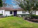 Well-maintained front yard featuring lush green grass, mature trees, and manicured shrubs at 623 Oak Hill Cir # 28, Sarasota, FL 34232