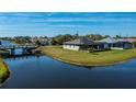 Waterfront home featuring beautiful landscaping, screened patio, and canal access at 855 Rotonda Cir, Rotonda West, FL 33947