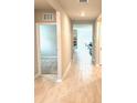 Well-lit hallway features neutral paint, access to multiple rooms, and attractive tiled flooring at 9516 Turtle Grass Cir, Punta Gorda, FL 33950