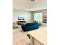 Bright living room with large window, stylish decor, and hardwood floors at 9516 Turtle Grass Cir, Punta Gorda, FL 33950