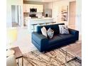 Open-concept living room showcases stylish furniture and flows into a modern kitchen with a breakfast bar at 9516 Turtle Grass Cir, Punta Gorda, FL 33950