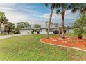 Single-story home with a garden in the front yard at 1052 Hinton St, Port Charlotte, FL 33952