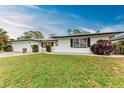 A single-story home with a lawn and garden at 1052 Hinton St, Port Charlotte, FL 33952