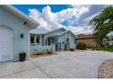 Charming single-Gathering home featuring light blue exterior paint, metal roof and manicured landscaping at 1334 Via Milanese, Punta Gorda, FL 33950