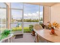 Relaxing screened porch overlooking the beautiful water view with table, chairs and tropical decorations at 1344 Rock Dove Ct # D102, Punta Gorda, FL 33950