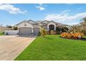 Charming home features a beautifully landscaped front yard, enhancing its curb appeal and welcoming ambiance at 1417 Carswell St, Port Charlotte, FL 33953