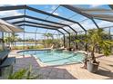 Inviting screened pool with a view of the pond, ideal for relaxing and enjoying the outdoors at 1417 Carswell St, Port Charlotte, FL 33953