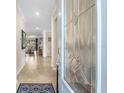 Inviting foyer with a decorative glass door and beautiful interior finishes at 17917 Wayside Bnd, Punta Gorda, FL 33982