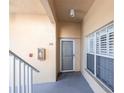 Condo entrance featuring unit number, storm door, and a white-framed window with privacy shutters at 2081 Willow Hammock Cir # F101, Punta Gorda, FL 33983