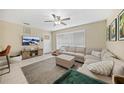 Inviting living room featuring a comfortable sectional sofa, ceiling fan and neutral tones at 2271 Hariet St, Port Charlotte, FL 33952