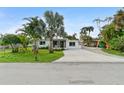 Charming single-story home with a well-maintained lawn and long driveway at 23475 Harper Ave, Port Charlotte, FL 33980