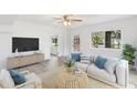 Bright living room featuring wood flooring, neutral walls, ceiling fan, and stylish decor at 23475 Harper Ave, Port Charlotte, FL 33980