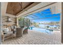 Inviting outdoor living space with a covered patio, pool, and lake view at 24362 Peppercorn Rd, Punta Gorda, FL 33955