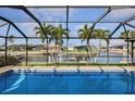 Screened in pool with blue water and view of canal at 611 Bal Harbor Blvd, Punta Gorda, FL 33950
