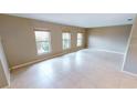 Spacious living room featuring large windows, neutral walls, and tiled flooring at 931 Bal Harbor Blvd, Punta Gorda, FL 33950